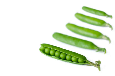 green ripe peas, green beans on a white background, vegetarian food close upの写真素材