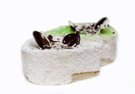 slice of cake in white glaze with chocolate bar, close up