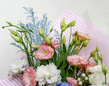 eustoma and hydrangea natural bright flowers in a bouquet, a gift for the holiday on the table, close-upの写真素材