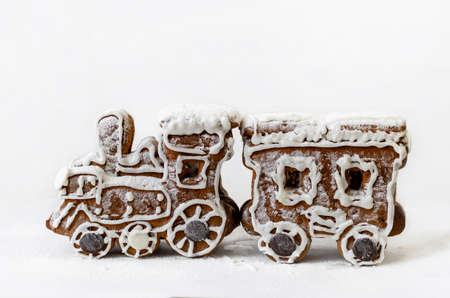 christmas gingerbread in the form of a steam locomotive with a wagon, on a light background close-upの写真素材