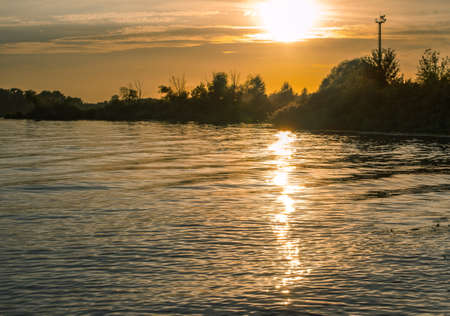 sunset sun reflection in water, beautiful autumn evening landscapeの写真素材