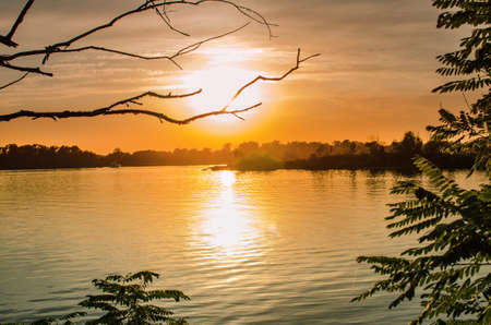 sunset sun reflection in water, beautiful autumn evening landscapeの写真素材