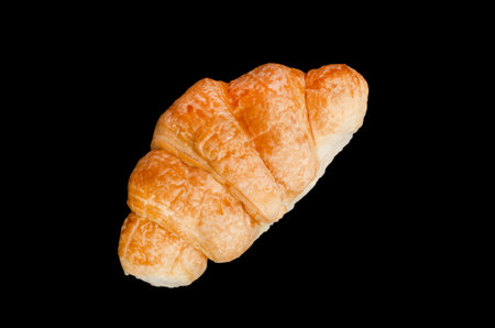 fresh golden croissant on black backggolden croissant, delicious pastry isolated on black backgroundroundの写真素材
