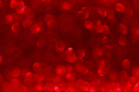 Christmas abstract red background, red glitter bokeh defocused.