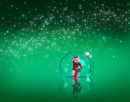 Beautiful Christmas decoration with a transparent ball and a figurine with reflection on a blue background. Festive background with copy space.の写真素材