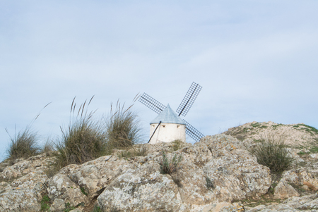 White old windmill on the hill near Consuegra (Castilla La Mancha, Spain), a symbol of region and...
