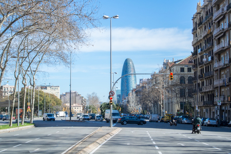 BARCELONA, SPAIN - FEBRUARY 12, 2014: A view of a street of Barcelona with cars, people and modern buildings, Catalonia, Spain.のeditorial素材