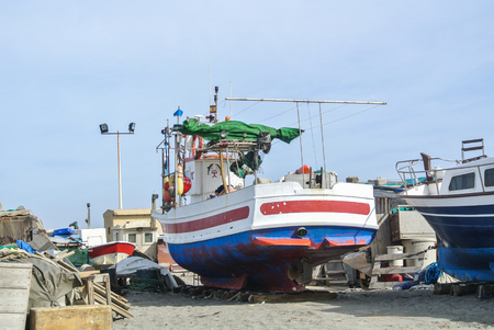 CABO DE GATA, SPAIN - FEBRUARY 9, 2016: Fishing boats at the shore of national park Cabo de Gata near Almeria (Andalusia, Spain) and sea waves on the background.のeditorial素材