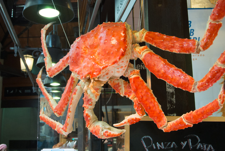 MADRID, SPAIN - FEBRUARY 12, 2017: A big crab hanging at San Miguel Market at Madrid, Spain.のeditorial素材
