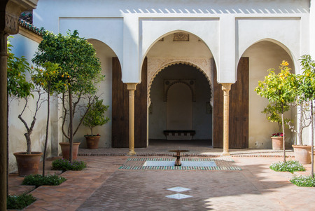 MALAGA, SPAIN - FEBRUARY 16, 2014: A quiet yard at Alcazaba, a castle of Malaga, with orange trees at pots, fountains and arch entrance in arab style, Andalusia, Spain.のeditorial素材