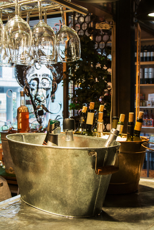 MADRID, SPAIN - FEBRUARY 12, 2017: Wine bottles in ice at Madrid San Miguel market, Spain.のeditorial素材