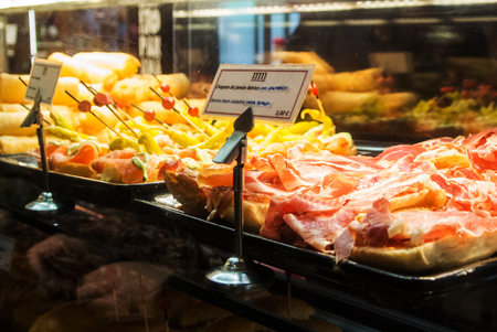 MADRID, SPAIN - FEBRUARY 12, 2017: Glass case with different tapas at Madrid San Miguel market, Spain.のeditorial素材