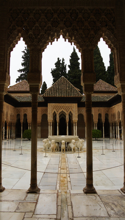 GRANADA, SPAIN - FEBRUARY 10, 2015: An archway to Court of the Lions with fountain at Alhambra palace, Granada, Andalusia, Spain.のeditorial素材