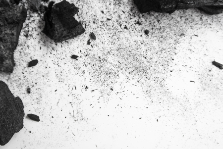 Black abstract textured composition on a white background, a selected focus close-up of a pile of cubes and powder of black mineral coal.の写真素材