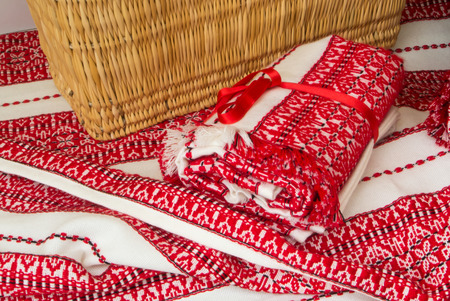 FRANKFURT, GERMANY - JUNE 4, 2017: Wicker handmade basket standing at white with red croatian ethnic embroidered fabric tablecloth at Croatian street market, the center of Frankfurt am Main, Germany.のeditorial素材