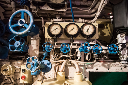 KALININGRAD, RUSSIA - JUNE 12 2017: Close-up view of monometrs, blue valves of different sizes, buttons and tubes, an engineering interior of a submarine B-413 (NATOâs Foxtrot), a museum vessel.のeditorial素材