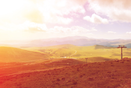 Toned panoramic view over the Carpatian mountains, green valleys and beautiful blue sky at the background, Bucegi natural park, Romania, on sunny summer day.の写真素材