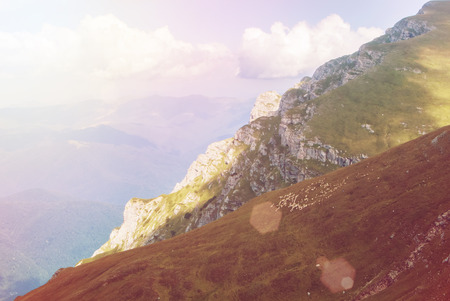 Toned panoramic view over the Carpatian mountains, green valleys and beautiful blue sky at the...