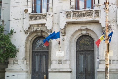 BUCHAREST, ROMANIA - JULY 29, 2017: Archetecture, state flags and trees in the central street of...