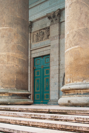ESZTERGOM, HUNGARY - JULY 27, 2016: Entrance to Esztergom Church Basilica Cathedral, a wooden green decorated door and big stone columns.のeditorial素材