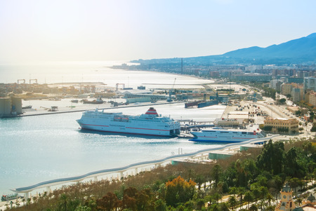 MALAGA, SPAIN - FEBRUARY 16, 2014: Panoramic view to the port of Malaga and big cruise ships from the Gibralfaro Castle, Andalusia, Spain, on sunny evening.のeditorial素材