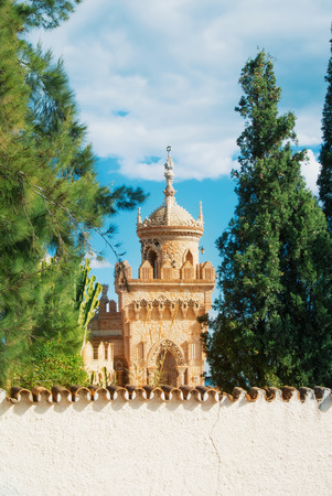 BENALMADENA, SPAIN - FEBRUARY 06, 2015: Close-up view to a tower of Colomares castle in Benalmadena, dedicated to Christopher Columbus, and green trees around. Malaga province, Costa del Sol.のeditorial素材