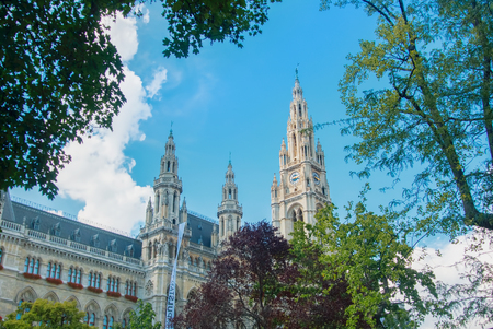 VIENNA, AUSTRIA - JULY 29, 2016: City hall (Rathaus) ant high trees in the park on sunny summer day at Vienna, Austria.のeditorial素材