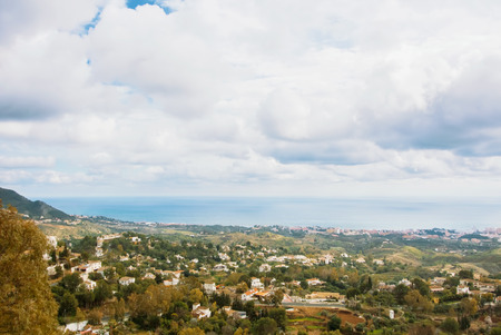 Aerial panoramic beautiful view from the park of Mijas, seascape of Mediterranean sea and surroundings of Fuengirola town on winter cloudy day, Andalusia, Spain.の写真素材