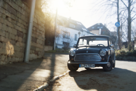 STUTTGART, GERMANY - DECEMBER 29, 2017: Old retro classic vintage oldtimer black mini copper car vehicle standing parked in the street near the stone wall.のeditorial素材