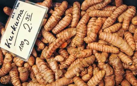 Fresh turmeric, kunyit, kunir, or kurkuma for sale on open street city market in Stuttgart, Germany.の写真素材