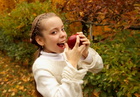 Girl eating an appleの写真素材