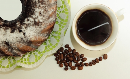 Chocolate cake, a cup of coffee and coffee beansの写真素材
