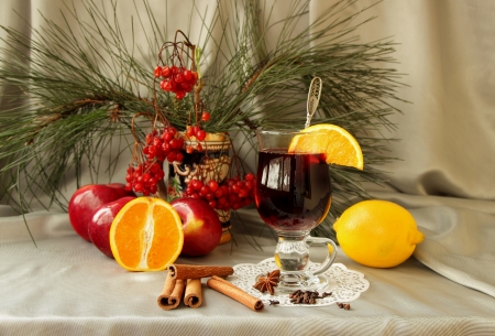 Glass of mulled wine, apples, oranges, cinnamon sticks and spicesの写真素材