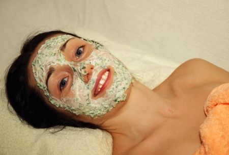 Girl with application of moisturizing mask on the face and smiling happyのeditorial素材
