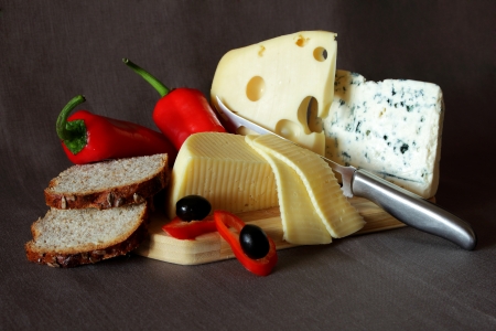 Blue cheese,cheese with holes,bread, red pepper and knifeの写真素材