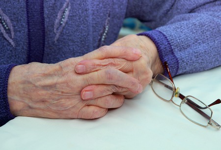 Grandmother hands folded in castleの写真素材