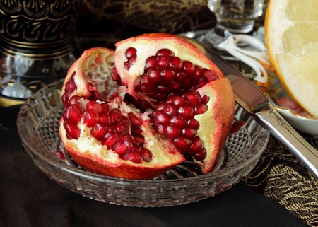 Juicy pomegranate on a plateの写真素材