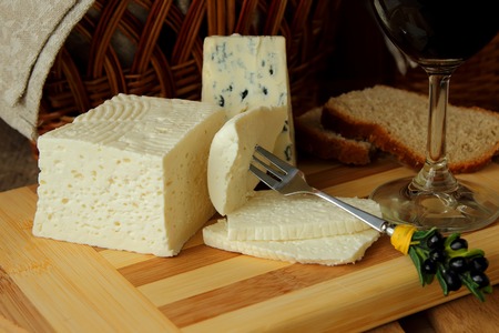 Home cheese, a slice of cheese on a fork and cheeseの写真素材