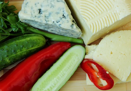 Cheese, homemade cheese and vegetables, top view