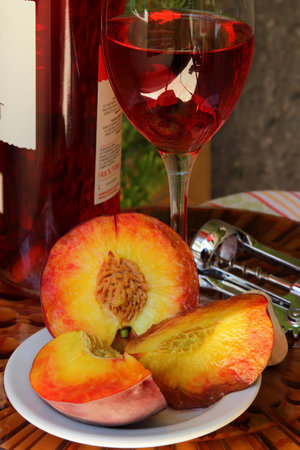 Glass of pink  wine and peaches 
の写真素材