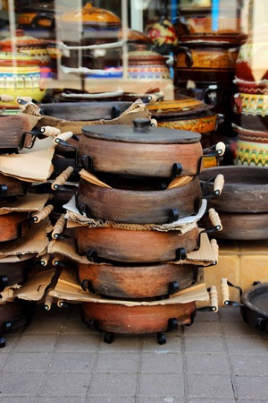 Stack of ceramic pans, placed near shopsの写真素材