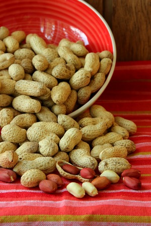 Loose peanuts from a plate on the table
