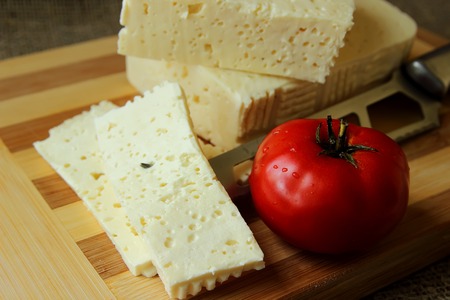 Home cheese, knife and tomato
の写真素材