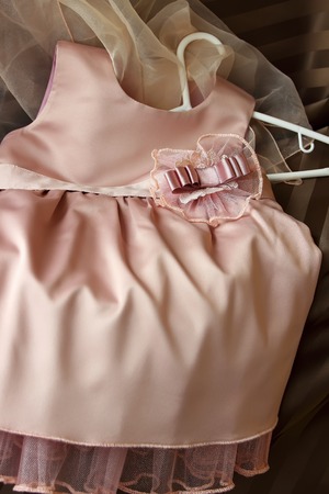 Children's silk dress with a decorative element on the beltの写真素材