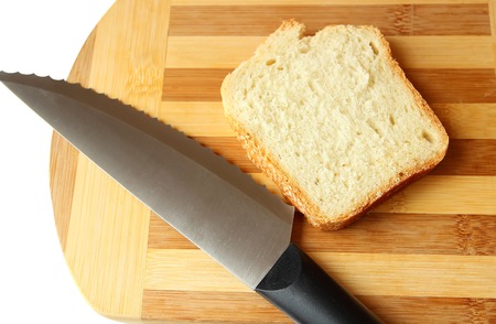 Slice of homemade bread and a knife on the board