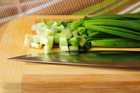 Green onions, sliced on the boardの写真素材