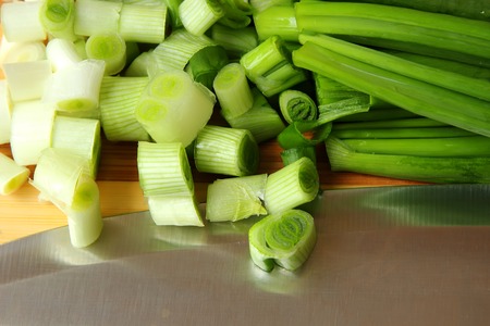 Green onions, sliced on the boardの写真素材