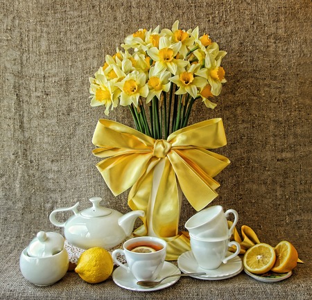 A festive tea party and a vase with daffodilsの写真素材