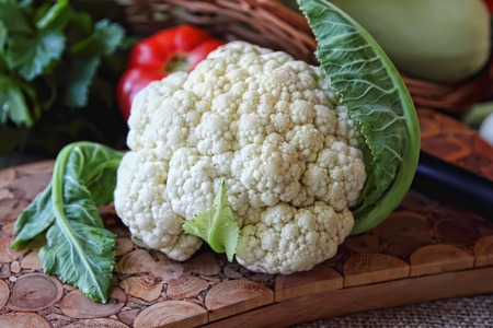 Cauliflower lying on the board for cooking dishesの写真素材
