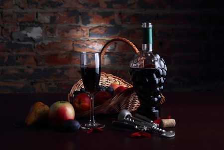 Still life with fruit and glass of wine on the background of a brick wall.の写真素材